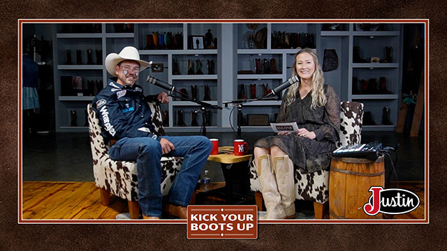 A woman with blonde hair and a man wearing a white cowboy hat looking at the camera, smiling, sitting, and having a conversation.